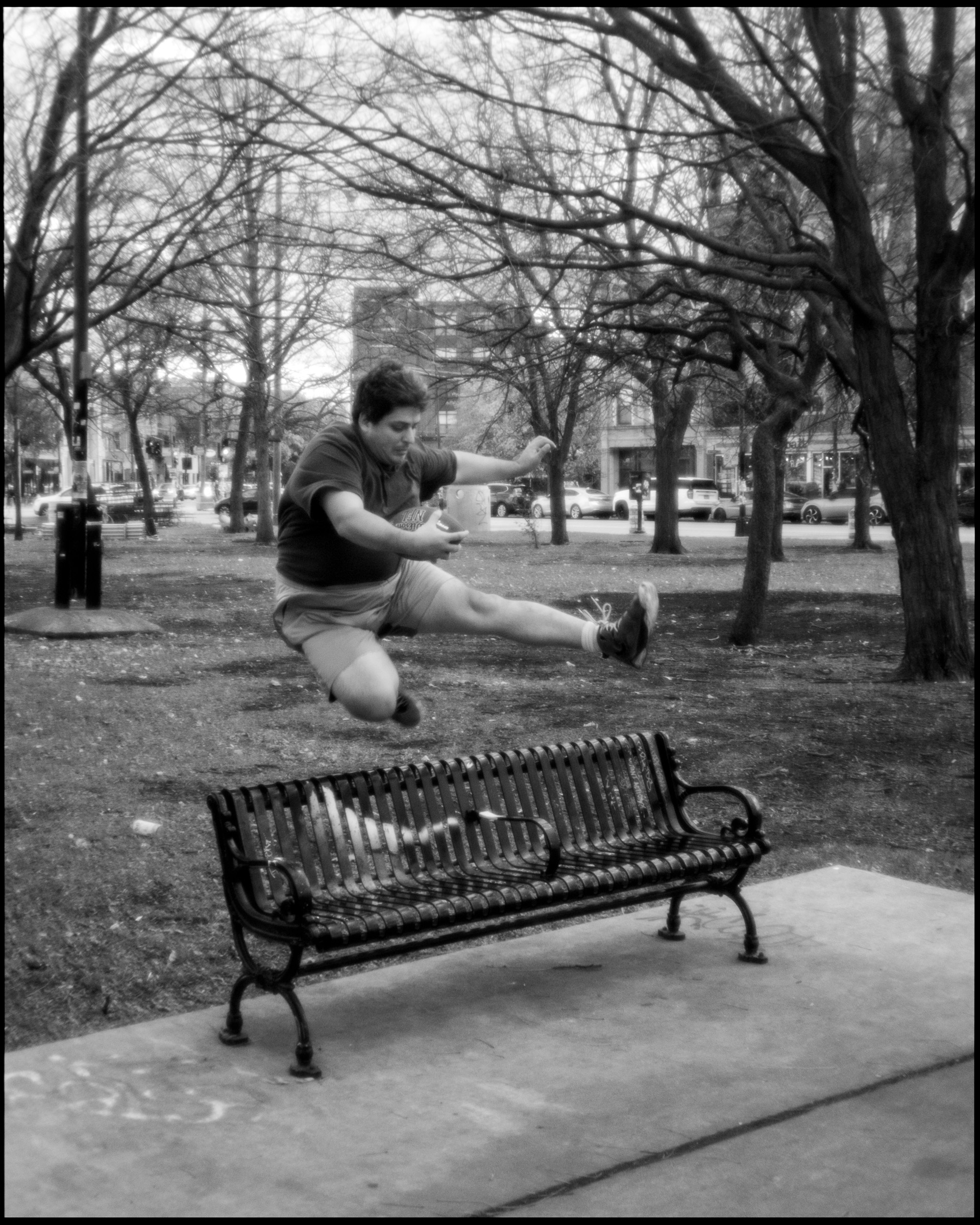 Person sitting by the monument with football, Logan Square Chicago 2024
